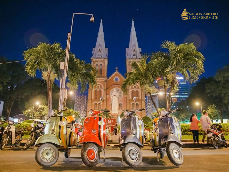 Ho Chi Minh City: Bespoke Vespa Street Food Tour Tourists on a bespoke Vespa street food tour in Ho Chi Minh City, experiencing local culture and cuisine at night.