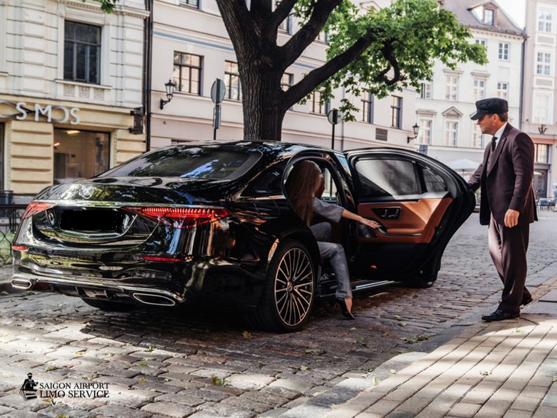 Saigon Airport Limo: Private Chauffeur Service Vietnam Professional private chauffeur standing beside a luxury Mercedes-Benz, ready to provide bespoke service for clients in Vietnam.