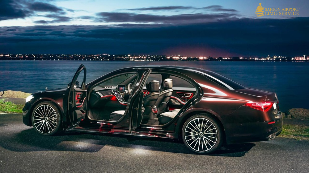 Saigon Airport Limo: Mercedes S-Class Luxury Interior A black Mercedes-Benz S-Class luxury limousine with all doors open, showcasing its illuminated, spacious interior at night, part of Saigon Airport Limo's premium fleet.